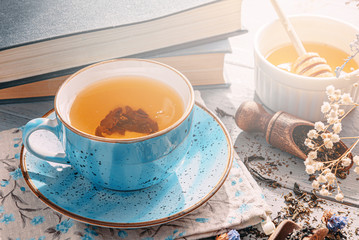 tea in a blue porcelain cup on a table in the sun