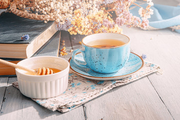 tea in a blue porcelain cup on a table in the sun