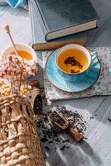 tea and a book in the spring sunshine. near honey and flowers