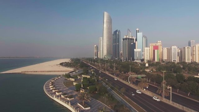 Abu Dhabi aerial skyline on a sunny day, going up in the sky with a drone