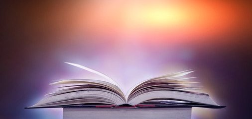 Imagine a picture book of an ancient book opened on a wooden table with a sparkling golden background. With magical power, magic, lightning around a glowing glowing book In the room of darkness