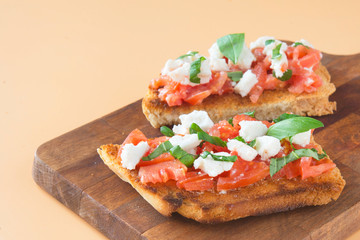 Italian bruschetta with tomatoes, mozzarella cheese and basil