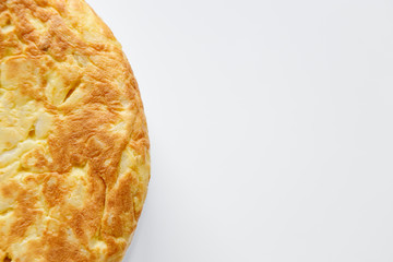 Detail of a Spanish omelette on a white background with copy space