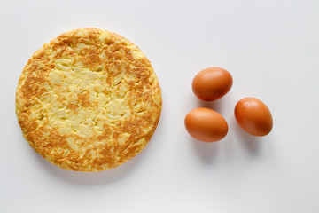 Delicious Spanish omelette with a few eggs on a white background