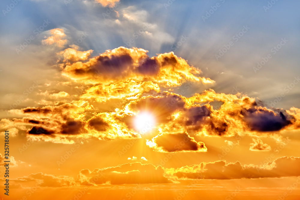 Canvas Prints sunset sky landscape background natural color of evening cloudscape with setting sun rays coming thr
