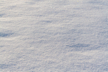 The shiny surface of the snow, sparkling with different colors.