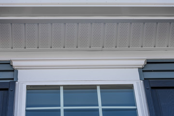 White soffit providing optimal ventilation for roof overhangs. Double pane window framed with a...