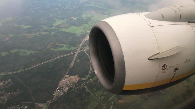 Big Turbofan Engine Flying Close Up. Airplane Passenger View.