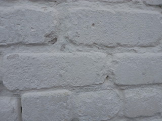 Wall of white lime painted bricks