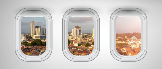 Airplane windows with Malacca skyline view, Malaysia. Travel and holiday abstract concept