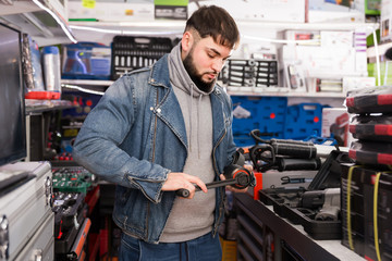 Adult man is buying new impact wrench