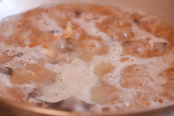 cooking and home concept - close up of female hands kneading dough at home,indian coconut  cocking
