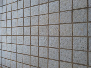 Outdoor grey floor tiles shown on an angle.