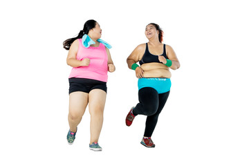 Full length of overweight women running in studio