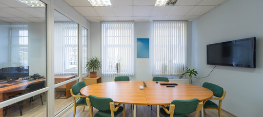 Modern meeting room in office with wooden furniture. Light interior. Panorama view.
