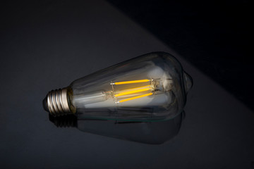 Light bulb on black background, idea concept with copy space