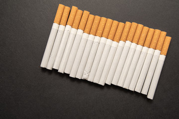 Cigarettes on black background close-up. Harmful to health. Bad habit.