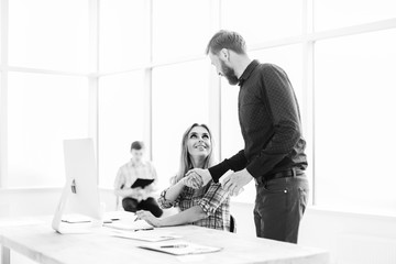 Manager and employee greeting each other in the workplace