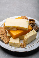 Cheese collection, matured and orange original British cheddar cheese in blocks served with crackers