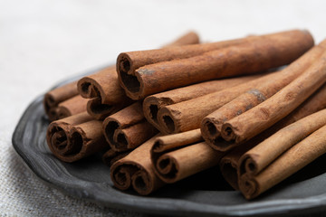 Winter food ingredient, dried aromatic cinnamon sticks on tin plate