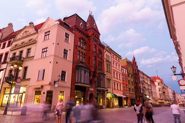 Fototapeta premium Night view of Torun streets and building illuminated at dusk