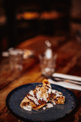 Shrove Tuesday, Pancake Day. Delicious pancakes served with fresh bananas, chocolate sauce and nuts. Concept of English traditions and food..
