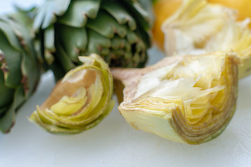 Cooking with fresh green artichokes heads, tasty vegetarian food