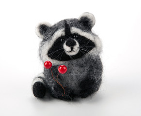 one handmade artificial raccoon toy on a white