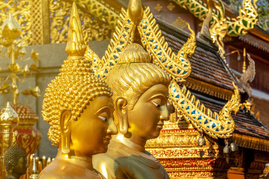 The golden Buddha images in the famous temple called Doi Suthep in the sunny day , public area. 