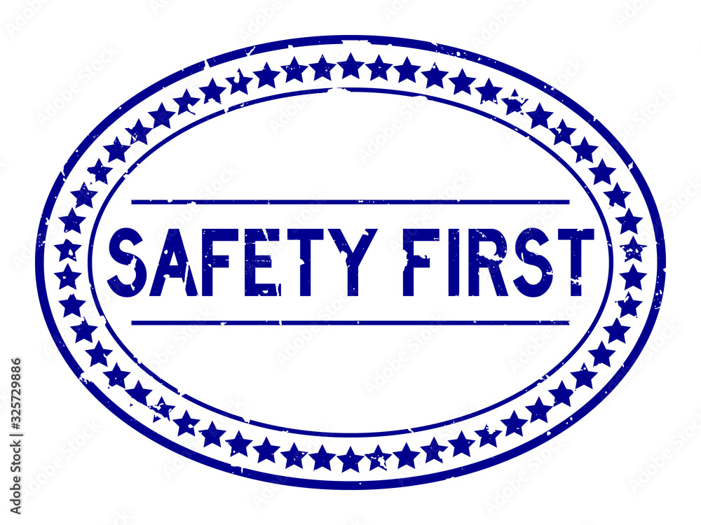 Wall mural grunge blue safety first word oval rubber seal stamp on white background