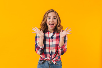 Image of young beautiful happy woman screaming and gesturing in delight