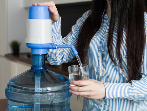 Woman drink water from delivered bottle