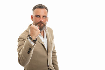 Portrait of man wearing smart casual clothes showing fist