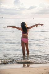 Young girl embracing ocean. Holiday and relax concept