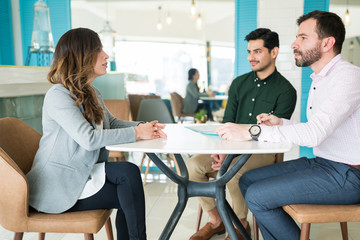 Candidates Discussing With Recruiters At Office Interview