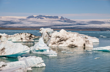 Iceland, Europe. Glacier ice floating on the water with snow at Jokulsarlon glacier lagoon in the winter time