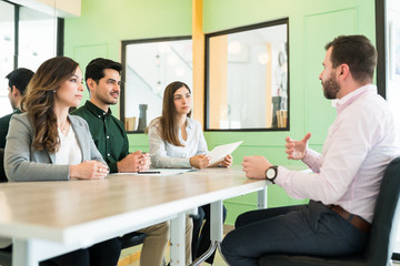 Applicant Discussing With Recruiters At Office