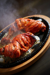 Tandoori chicken on hot iron plate 