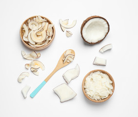 Composition with tasty coconut chips on white background, top view