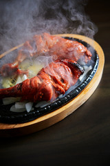 Tandoori chicken on hot iron plate 