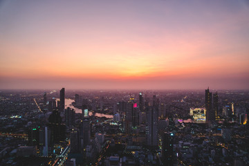 Fototapeta na wymiar Aerial view of Bangkok city at sunset, from Mahanakhon SkyWalk, Thailand, Asia