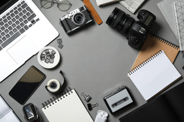 Flat lay composition with equipment for journalist on grey table, space for text