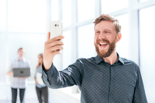 Handsome Man Takes A Selfie In The Office Lobby.