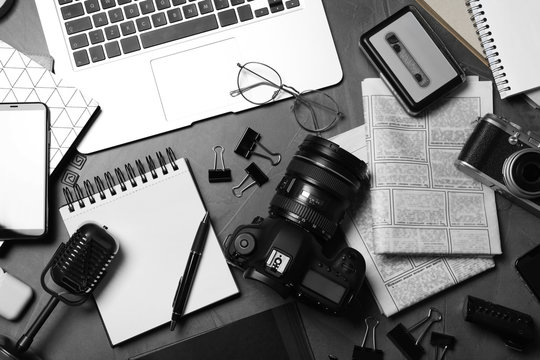 Flat lay composition with equipment for journalist on grey table