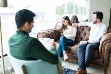 Husband And Wife Sharing Their Problems With Counselor