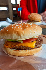 Burger with beef on a wooden table with gloves for food. burger order