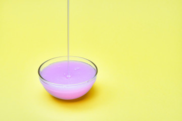 liquid soap is poured into a glass dish