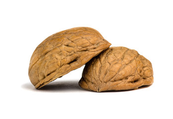 Delicious whole and broken walnuts, isolated on white background