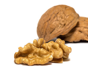 Delicious whole and broken walnuts, isolated on white background