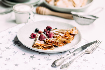 Pancakes with wild berries in a plate.Maslenitsa